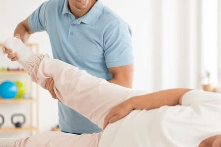 A Nurse Helping a Patient Lift Leg