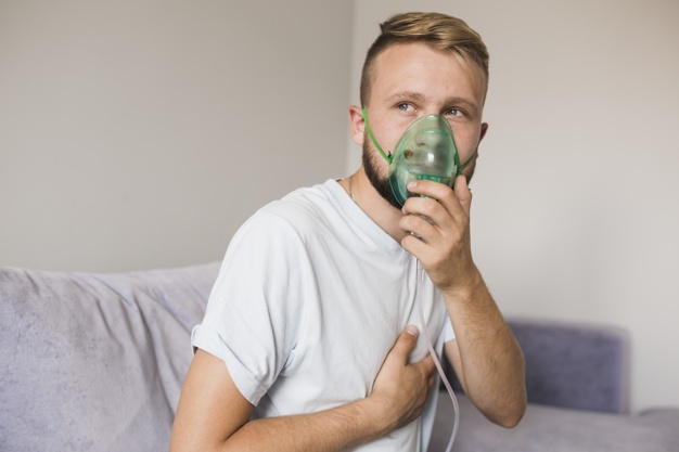 Man Using Nebulizer At Home