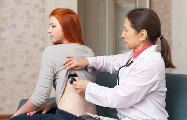 A Doctor Examining a Female Patient