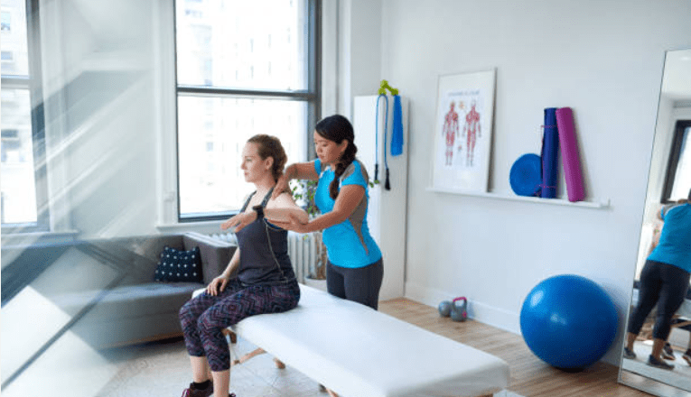 A Physiotherapist doing a therapy on a patient